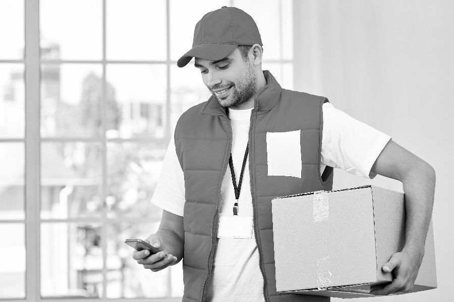 Cheerful Courier Holding Parcels and Looking for Customer refference Number