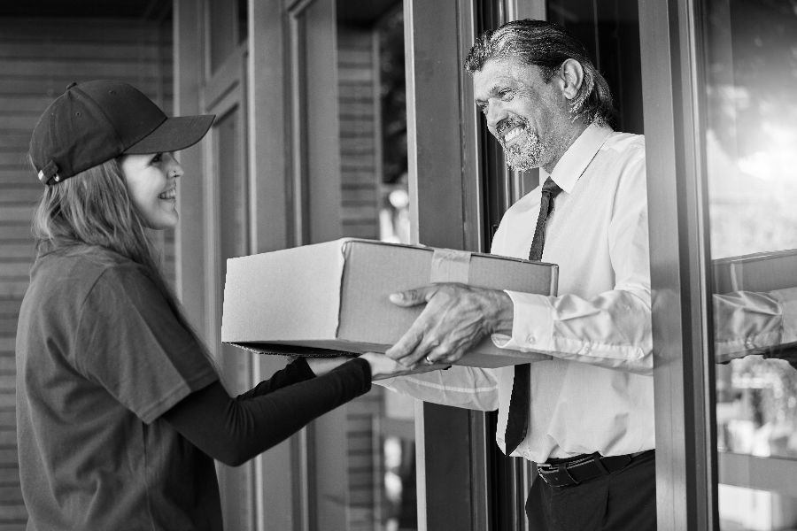 Delivery-Courier-and-Box-with-Business-Man-at-Front-Door