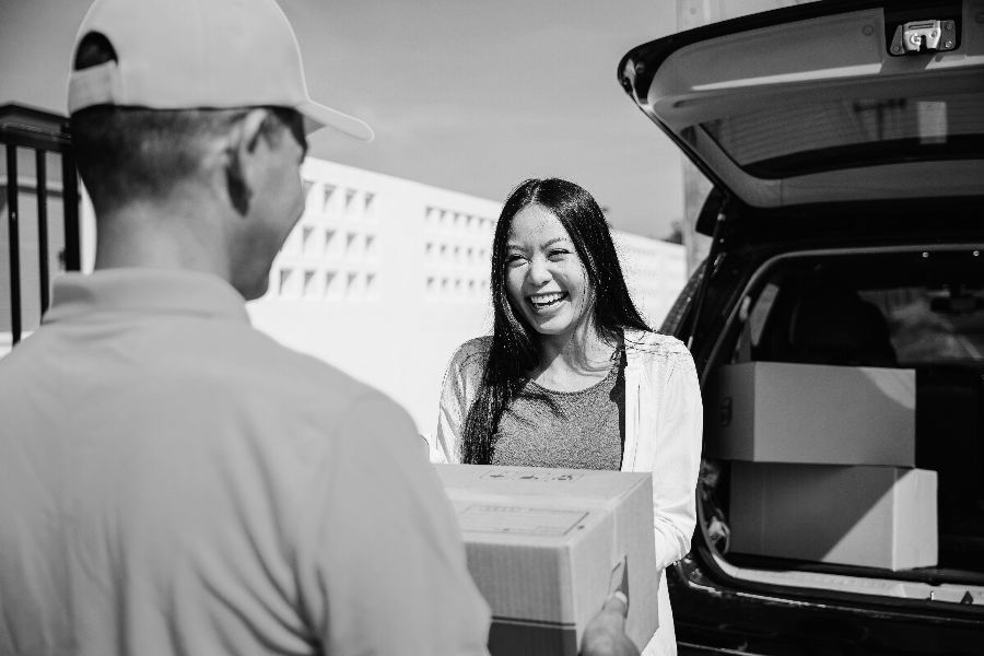 Efficient Overnight shipping Courier Delivering a parcel to a happy customer