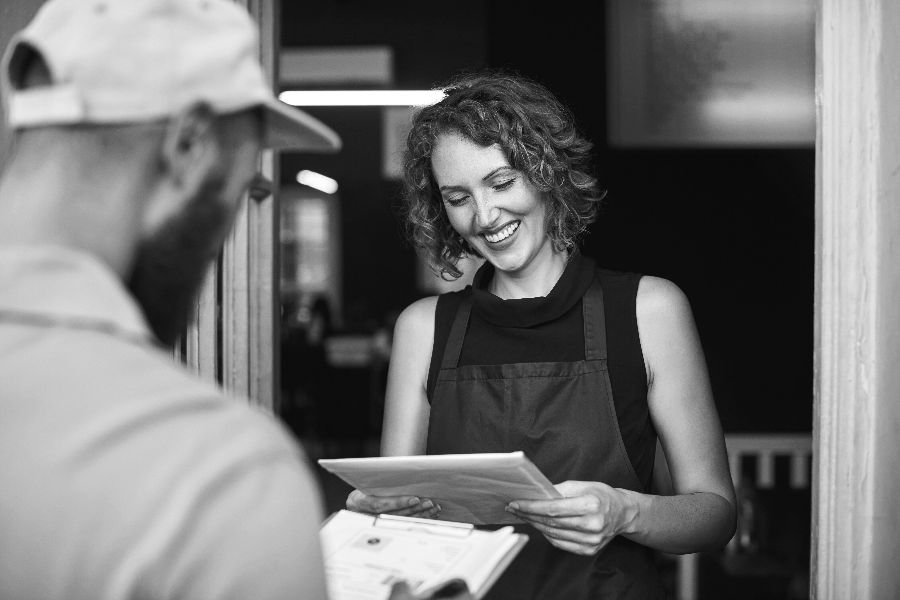 Courier-Making-a-Delivery-to-a-Smiling-Customer.