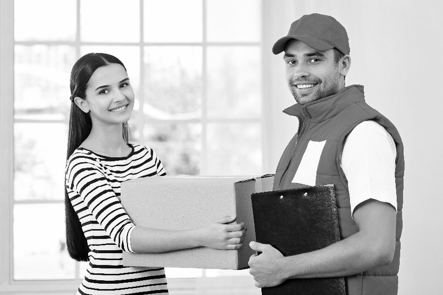 Young Woman Receiving Parcel from a courier